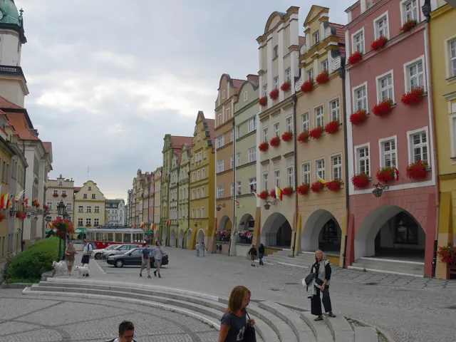The arcaded market square of Jelenia Góra with colourful tenement houses and the town hall tower