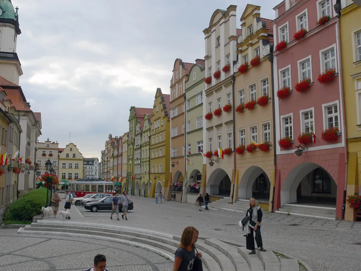 The arcaded market square of Jelenia Góra with colourful tenement houses and the town hall tower