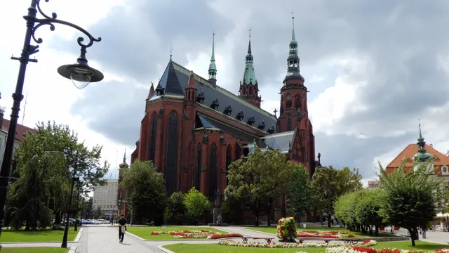 The red-brick Cathedral of Saints Peter and Paul in Legnica seen from the park