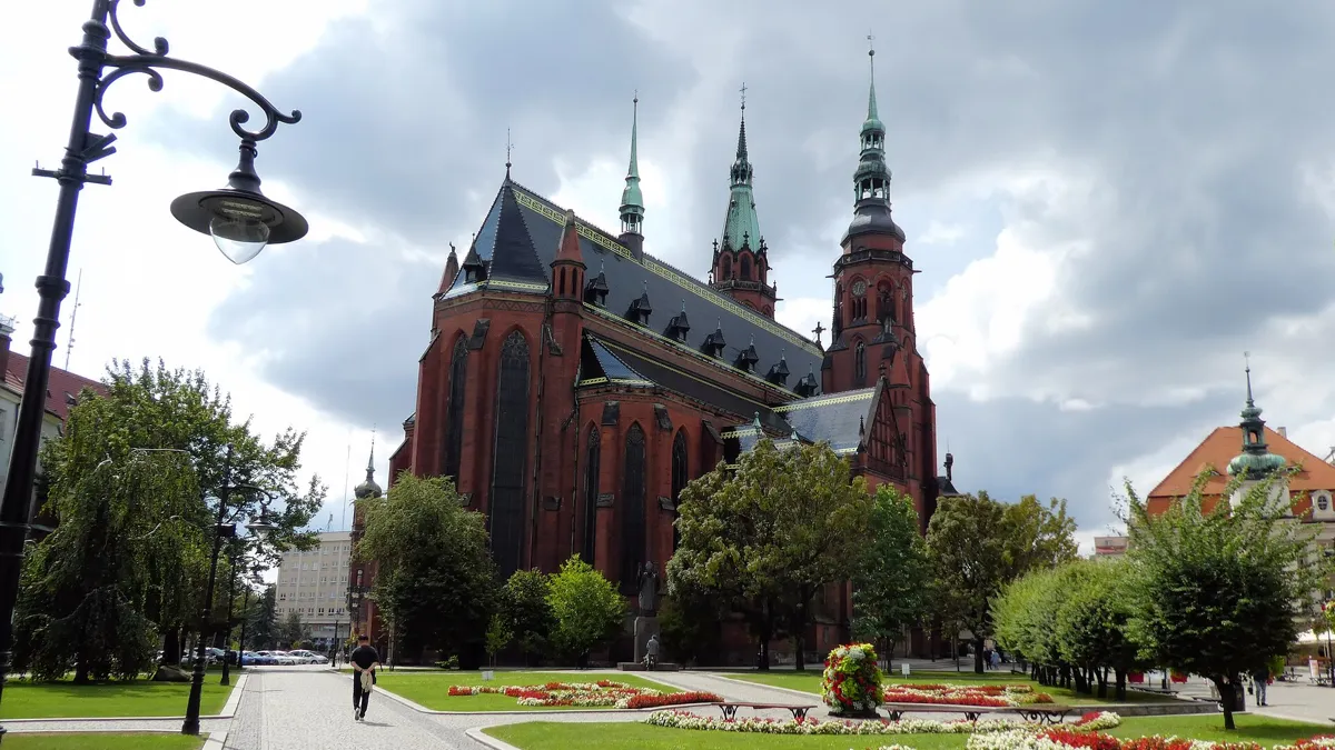 The red-brick Cathedral of Saints Peter and Paul in Legnica seen from the park