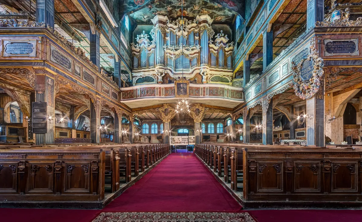 The richly painted and gilded interior of the Church of Peace in Świdnica with the organ and galleries