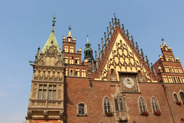 The gabled brick facade and astronomical clock of the Old Town Hall in Wrocław